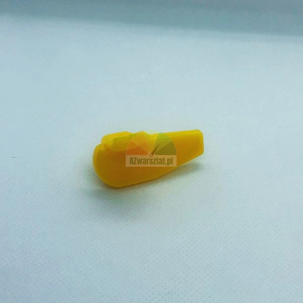 Mały żółty plastikowy element lub część zamienna na jasnym tle.